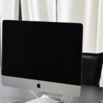 Fitbit Charge - Modern workspace with computer and smartphone on table