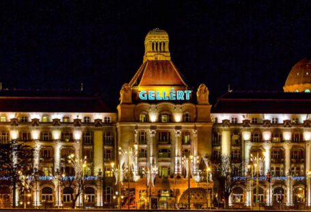 Grand Budapest Hotel - Aged palace with glowing lamps against night sky