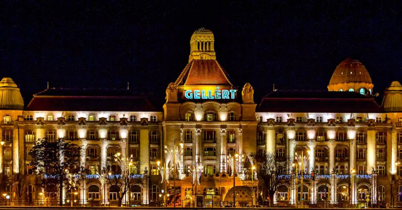 Grand Budapest Hotel - Aged palace with glowing lamps against night sky