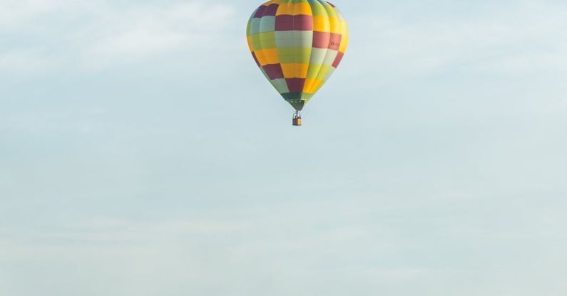 Hamilton - Checkered Hot Air Balloon over Green Pasture