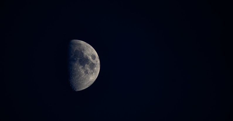 Dark Side Of The Moon - Minimalistic view of half moon with spots at cloudless dark sky at night
