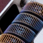Atomic Habits - Closeup of fused clapton coil on dripper of modern electronic cigarette on white background
