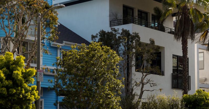 This Is Us - A car parked in front of a blue house