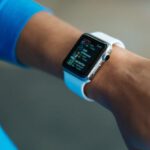 Fitbit Versa - Person Wearing White Silicone Strap Black Smartwatch