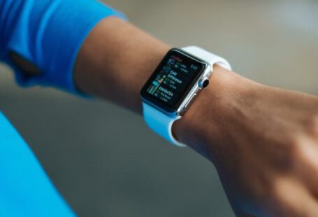 Fitbit Versa - Person Wearing White Silicone Strap Black Smartwatch