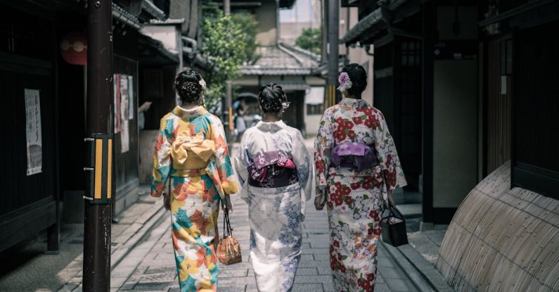 Kimono - Three Geisha Walking Between Buildings