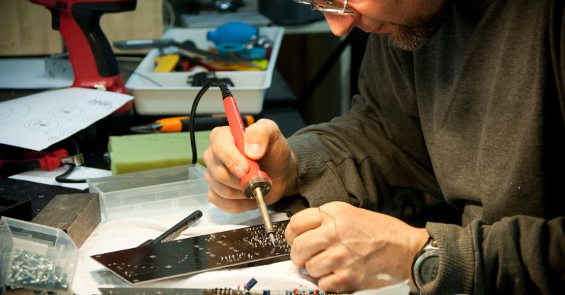 Guns, Germs, And Steel - Man Soldering Circuit Board