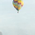 Hamilton - Checkered Hot Air Balloon Flying Above the Foggy City