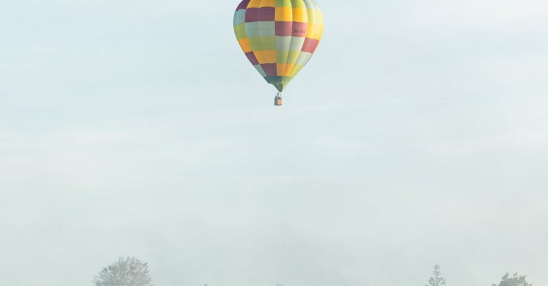 Hamilton - Checkered Hot Air Balloon Flying Above the Foggy City