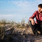 Doubt - Shallow Focus Photography of Man Wearing Red Polo Shirt