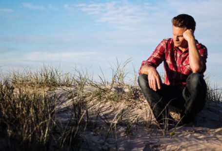 Doubt - Shallow Focus Photography of Man Wearing Red Polo Shirt