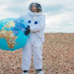 Lonely Planet - Astronaut Holding the Earth